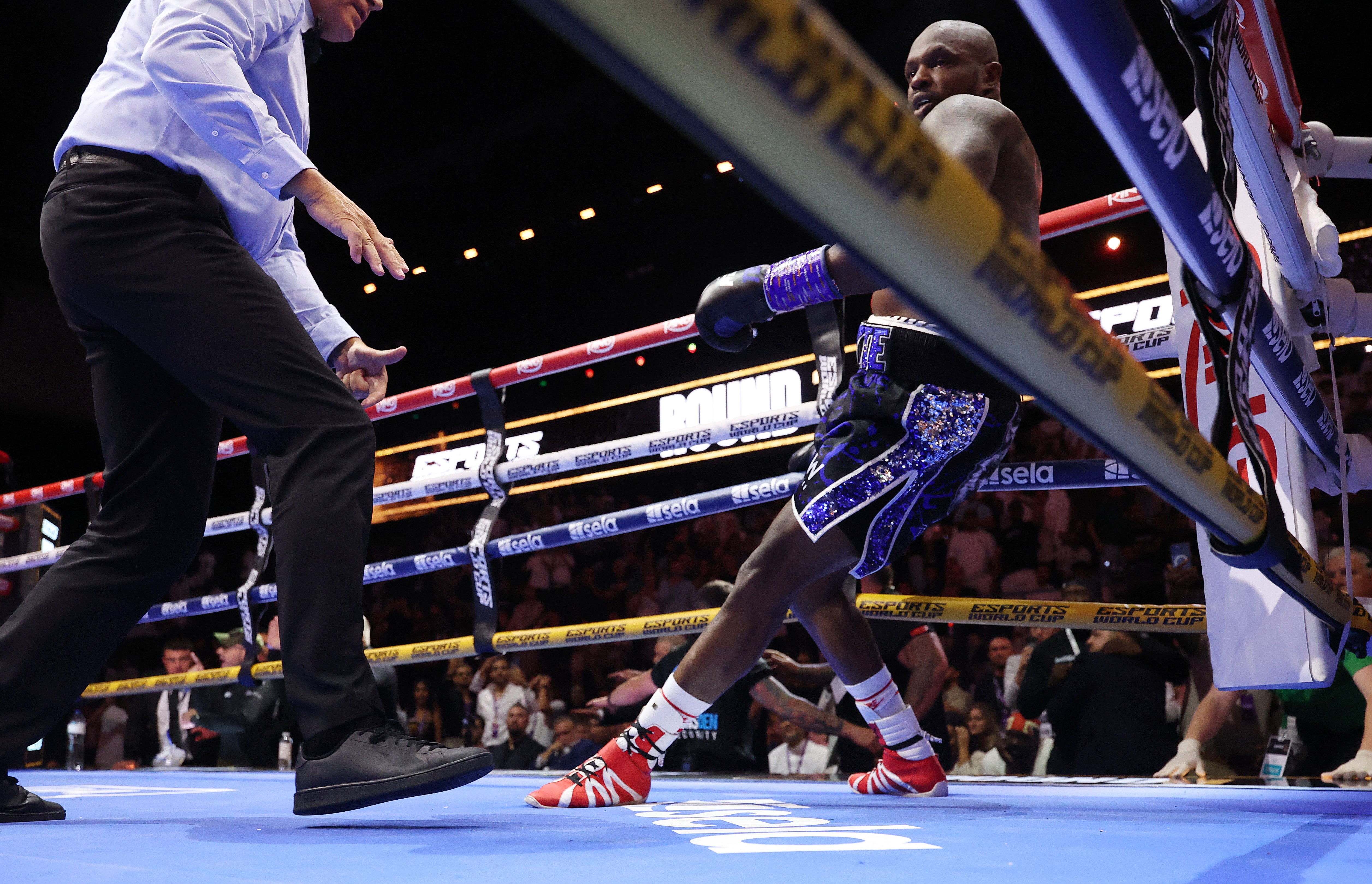 Whyte beats the count but stumbles into the corner