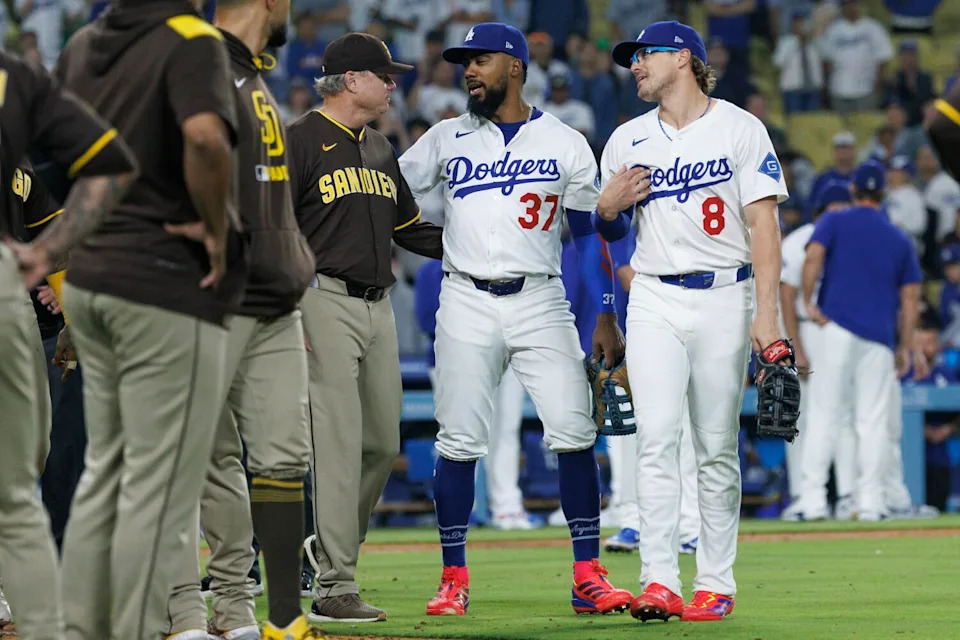 Dodgers Teoscar Hernandez (37) and Enrique Hernandez (8) calm things down as they walk with Padres manager Mike Shildt