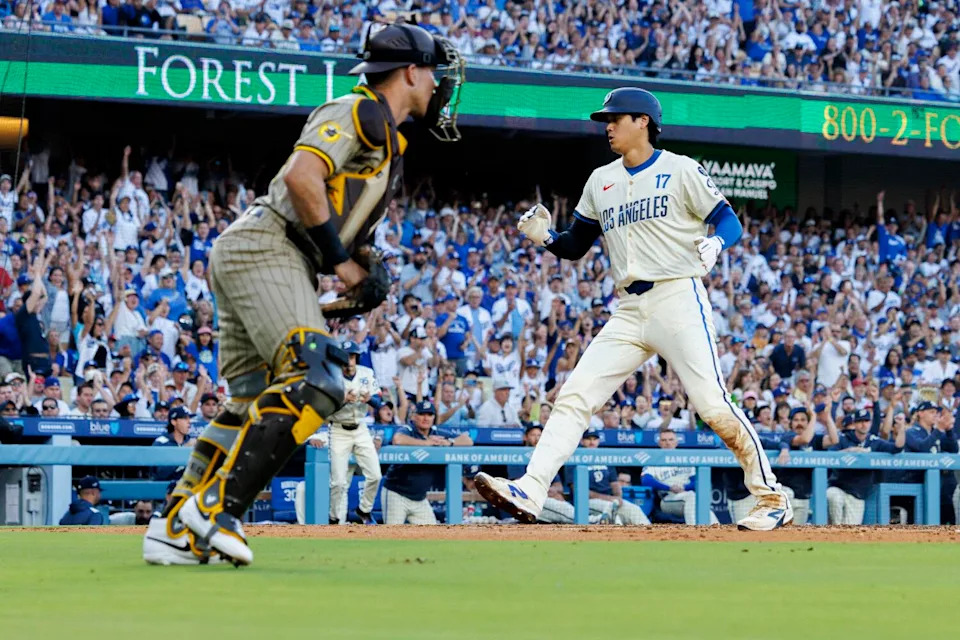 Dodgers star Shohei Ohtani scores on a sacrifice fly in the first inning Saturday against the Padres.
