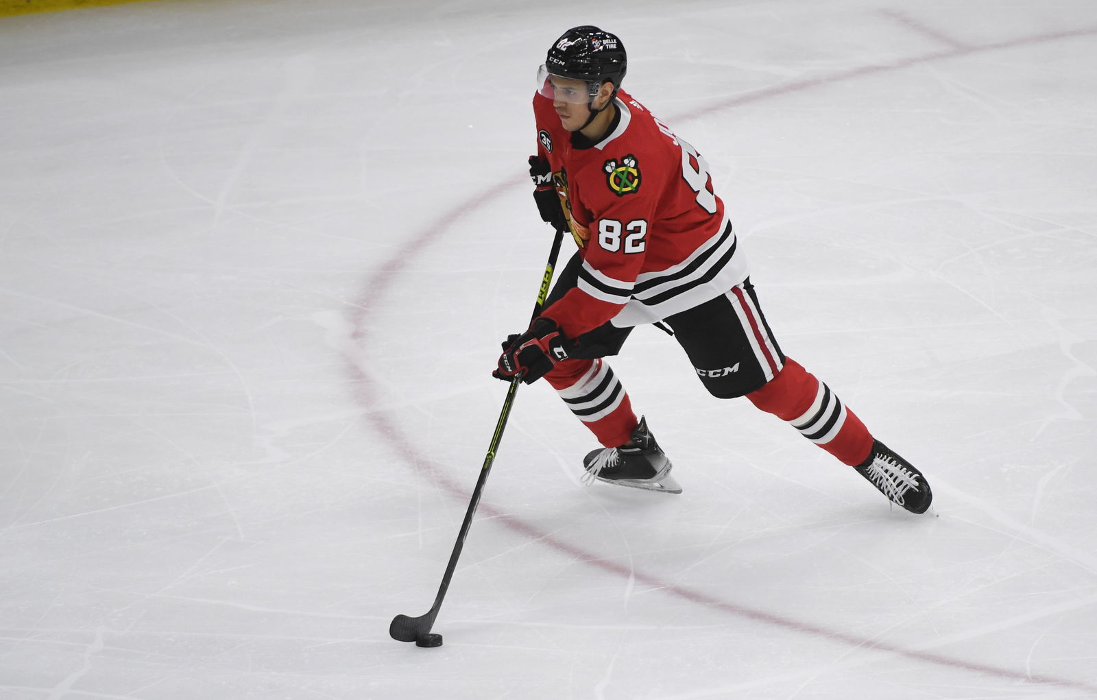 Apr 12, 2022; Chicago, Illinois, USA; Chicago Blackhawks defenseman Caleb Jones (82) moves the puck against the Los Angeles Kings during the third period at the United Center. Mandatory Credit: Matt Marton-Imagn Images