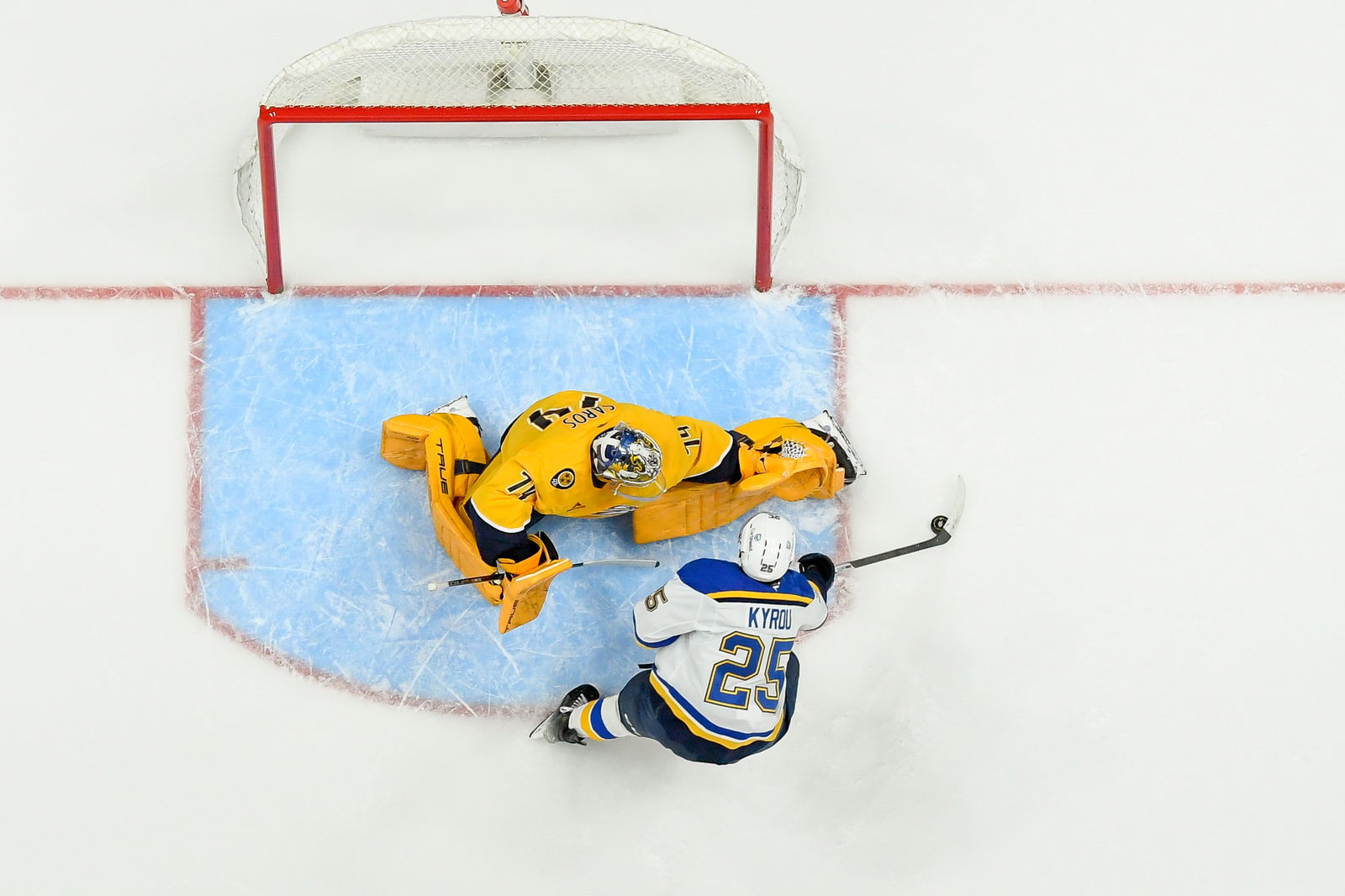 Mar 27, 2025; Nashville, Tennessee, USA; Nashville Predators goaltender Juuse Saros (74) blocks the shot of St. Louis Blues center Jordan Kyrou (25) during the third period at Bridgestone Arena. Mandatory Credit: Steve Roberts-Imagn Images