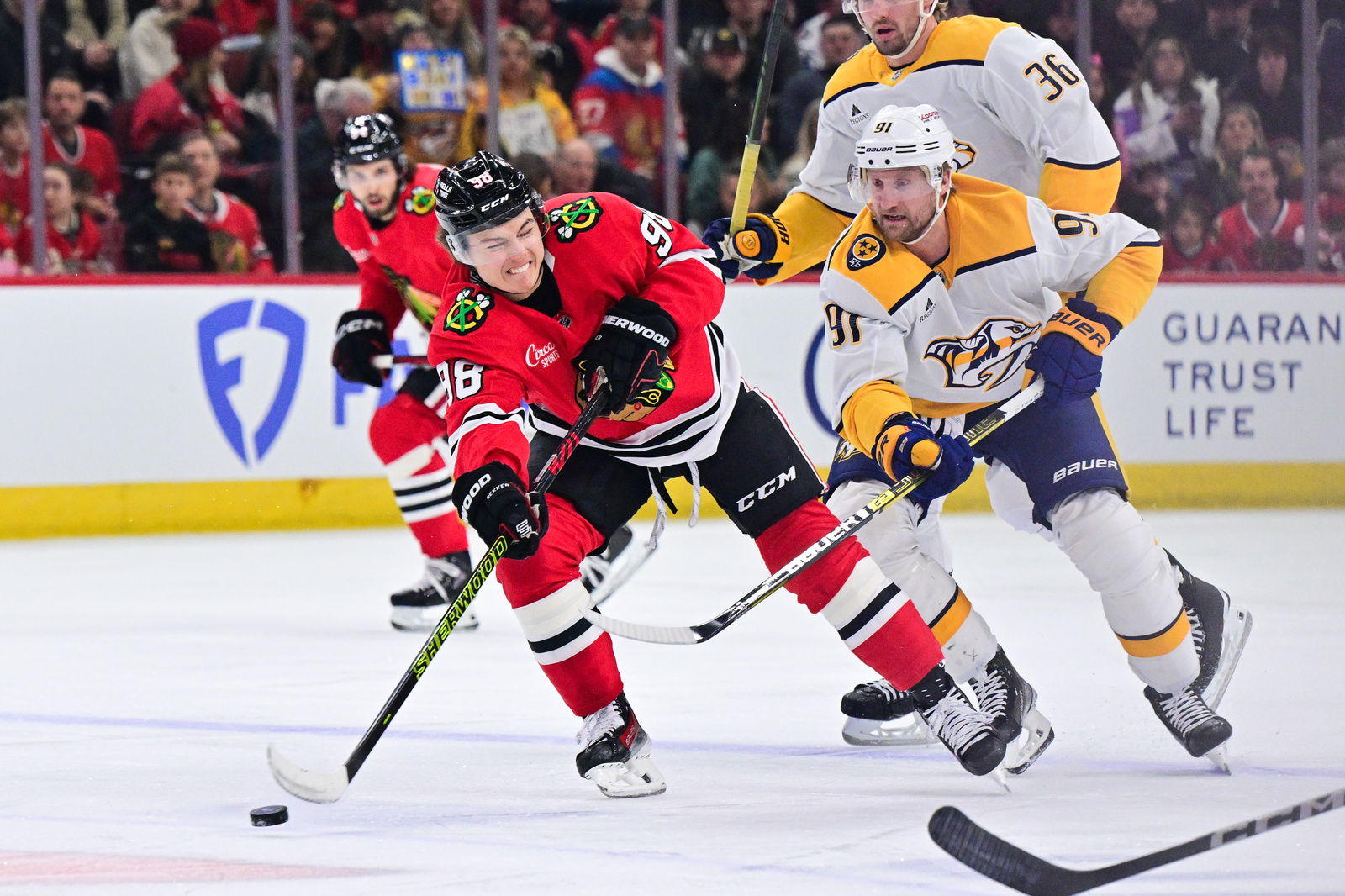 Feb 7, 2025; Chicago, Illinois, USA; Chicago Blackhawks center Connor Bedard (98) passes with the puck against the Nashville Predators during the first period at the United Center. Mandatory Credit: Daniel Bartel-Imagn Images