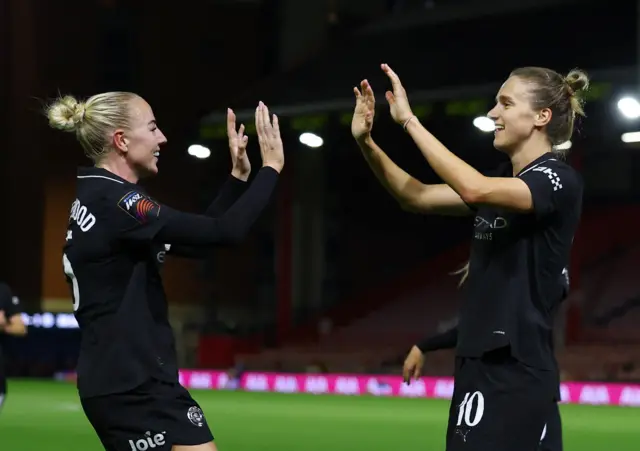 Alex Greenwood and Vivianne Miedema high-five.