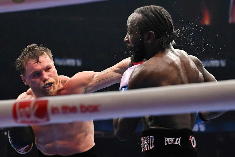 Canelo Álvarez punches Terence Crawford during an undisputed super middleweight championship boxing match.