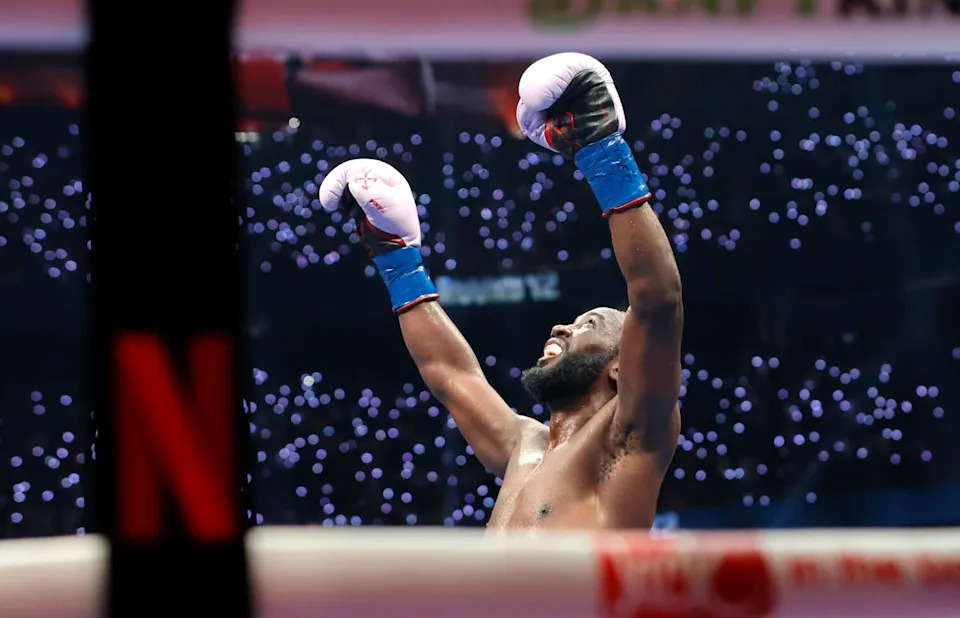 Terence Crawford raises his arms and looks up after the final bell of his fight with Canelo Álvarez, not pictured.