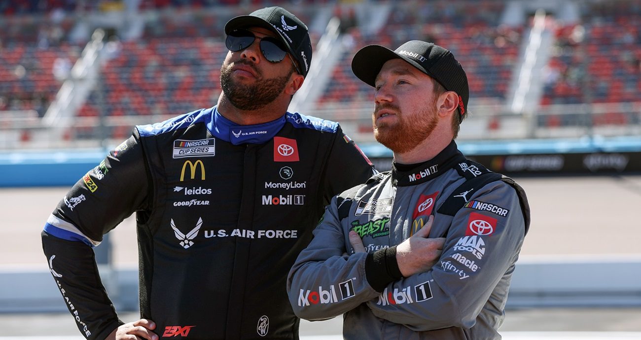 AVONDALE, ARIZONA - MARCH 09: Bubba Wallace, driver of the #23 U.S. Air Force Toyota, (L) and Tyler Reddick, driver of the #45 Mobil 1 Toyota, talk on the grid during qualifying for the NASCAR Cup Series Shriners Children\