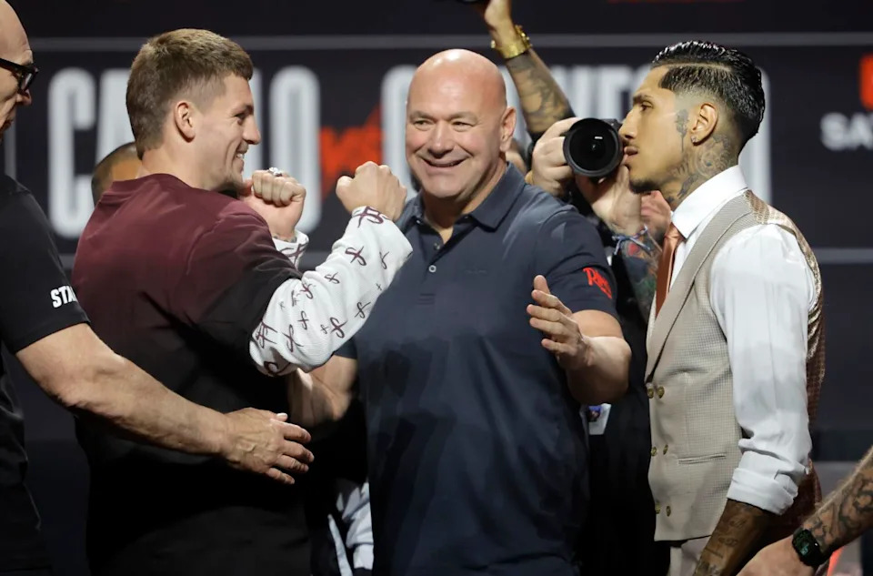 Boxers Callum Walsh and Fernando Vargas Jr. off during a news conference on Thursday while UFC's Dana White looks on.