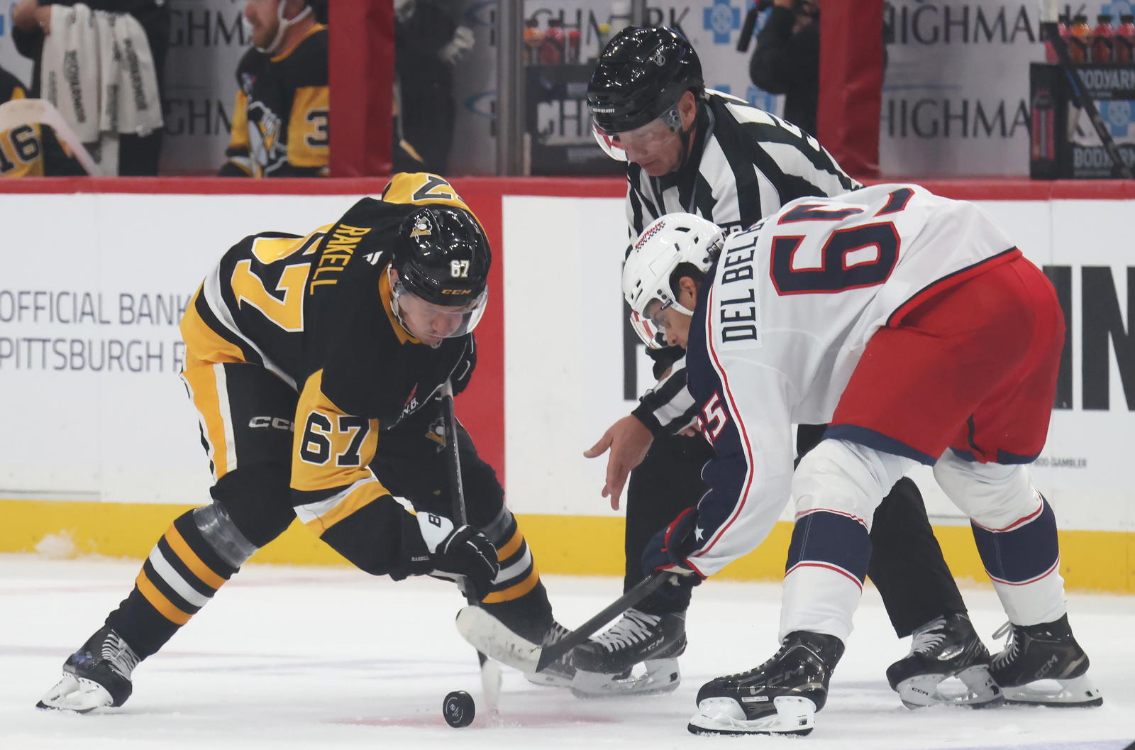 Sep 27, 2025; Pittsburgh, Pennsylvania, USA; Pittsburgh Penguins right wing Rickard Rakell (67) takes a face-off against Columbus Blue Jackets center Luca Del Bel Belluz (65) during the first period at PPG Paints Arena. Mandatory Credit: Charles LeClaire-Imagn Images