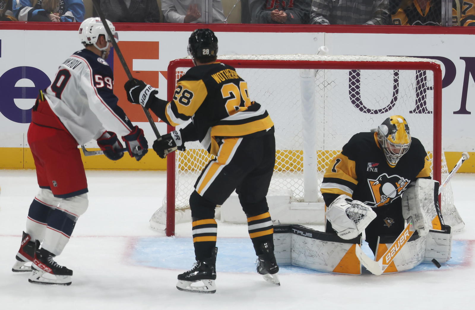 Sep 27, 2025; Pittsburgh, Pennsylvania, USA; Pittsburgh Penguins goaltender Sergei Murashov (1) makes a save as defenseman Parker Wotherspoon (28) defends Columbus Blue Jackets right wing Yegor Chinakhov (59) during the second period at PPG Paints Arena. Mandatory Credit: Charles LeClaire-Imagn Images