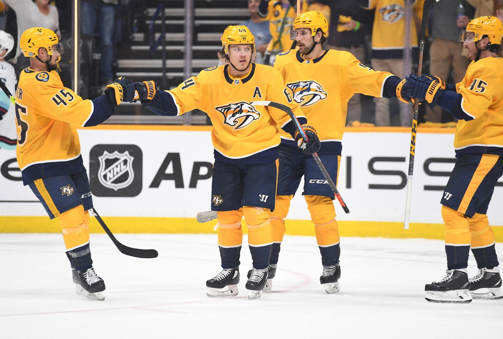 Oct 14, 2021; Nashville, Tennessee, USA; Nashville Predators center Mikael Granlund (64) is congratulated after a goal during the third period against the Seattle Kraken at Bridgestone Arena. Christopher Hanewinckel-Imagn Images