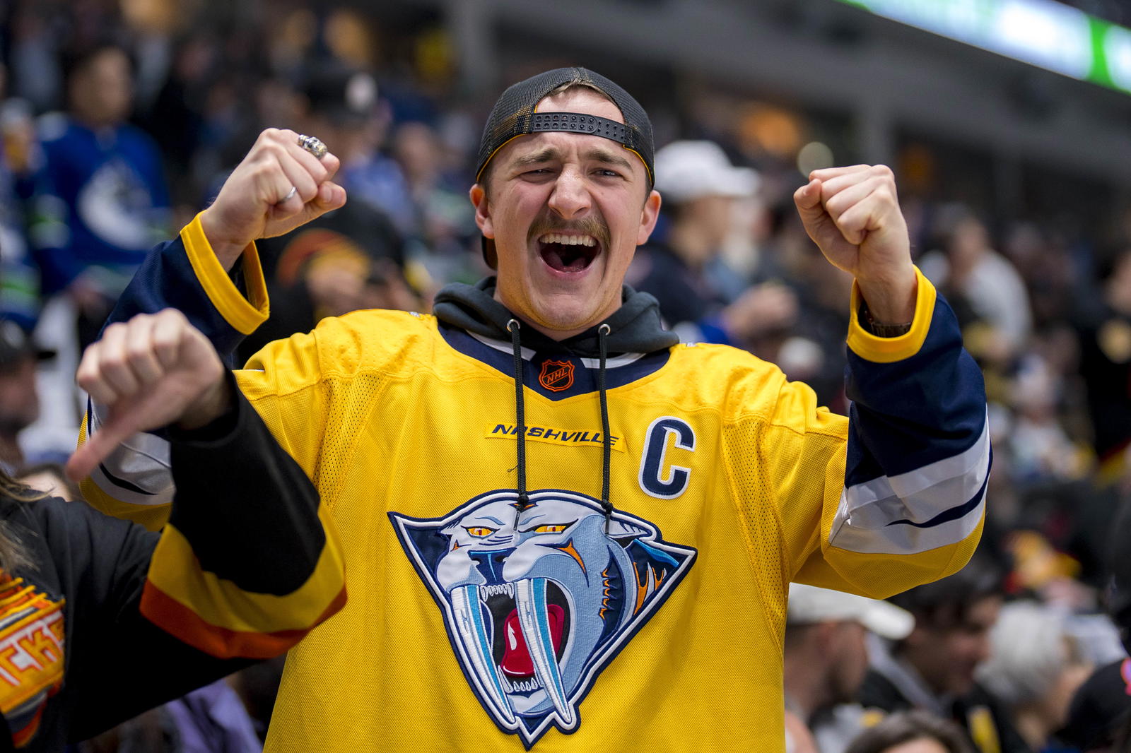Apr 30, 2024; Vancouver, British Columbia, CAN; A Nashville fan cheers in warm up prior to game five of the first round of the 2024 Stanley Cup Playoffs between the Nashville Predators and Vancouver Canucks at Rogers Arena. Mandatory Credit: Bob Frid-Imagn Images