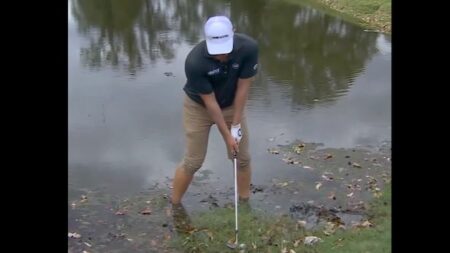 Watch this tour pro hit a shot while standing dangerously(!) close to a lurking alligator