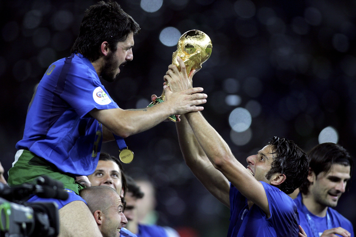 BERLIN - JULY 09: Gennaro Gattuso (L) and Fabio Grosso (R) of Italy celebrate with the world cup trophy during the FIFA World Cup Germany 2006 Final match between Italy and France at the Olympic Stadium on July 9, 2006 in Berlin, Germany. (Photo by Ben Radford/Getty Images)