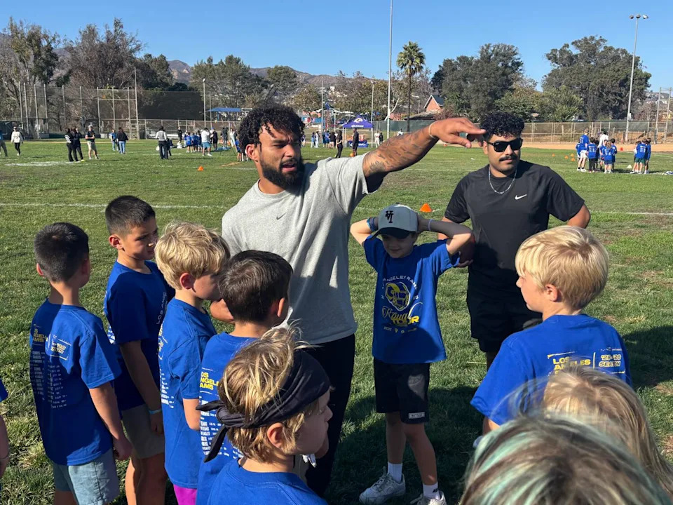 Rams running back Kyren Williams instructs young flag football players in Pacific Palisades on Oct. 7.