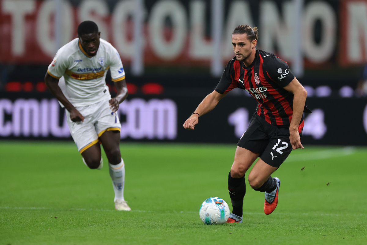 MILAN, ITALY - SEPTEMBER 23: Adrien Rabiot of AC Milan is pursued by Mohamed Kaba Drame of US Lecce during the Coppa Italia Frecciarossa Round of 16 match between AC Milan and US Lecce at Giuseppe Meazza Stadium on September 23, 2025 in Milan, Italy. (Photo by Jonathan Moscrop/Getty Images)