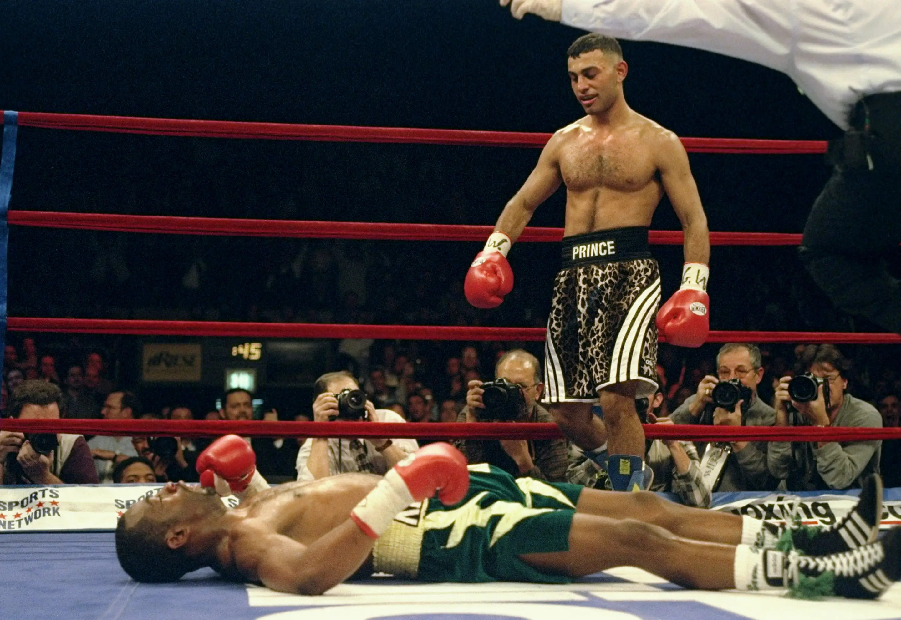 18 Dec 1997: Prince Naseem Hamed stands over Kevin Kelley during a fight at Madison Square Garden in New York City, New York. Hamed won the fight with a fourth round knockout. Mandatory Credit: Al Bello /Allsport