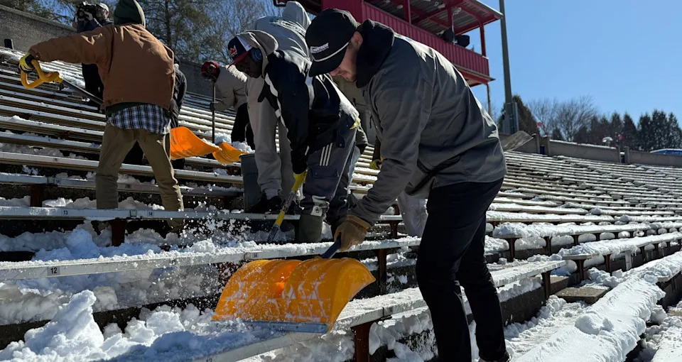 Todd Gilliland removes snow and ice from Bowman Gray Stadium grandstands.