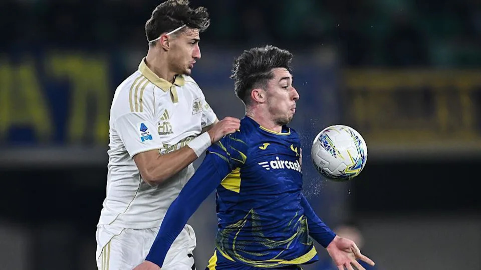  Rosen Bozhinov of Pisa competes for the ball with Kieron Bowie of Verona
