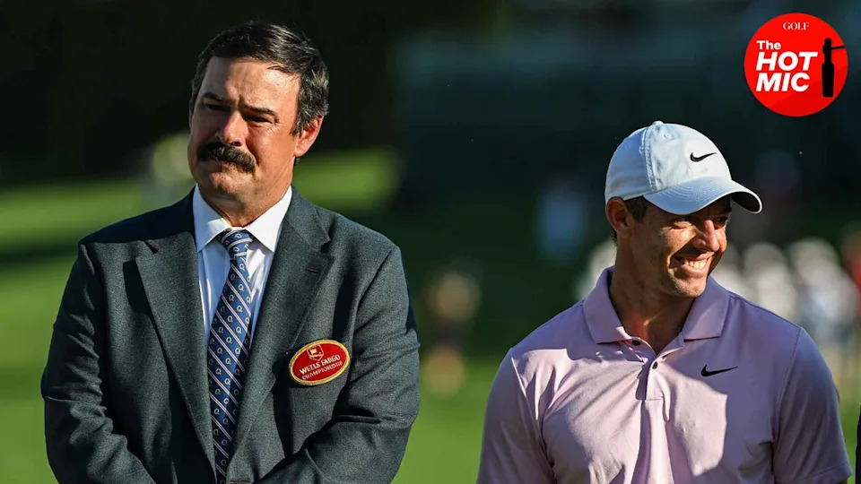 johnson wagner and rory mcilroy smile at a golf tournament in suit and white hat
