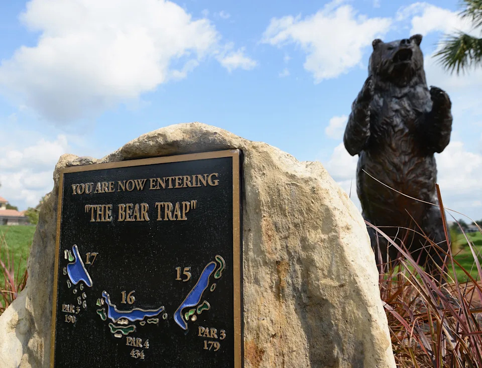 A sign and statue of a bear to mark the three holes known as the The Bear Trap at PGA National Resort and Spa.