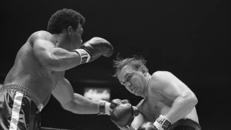 George Foreman makes a long left jab at Chuck Wepner in the second round of their fight, August 18th. Wepner's eye opened up slightly in the first, and was bad enough by the beginning of the third round to give Foreman a TKO.