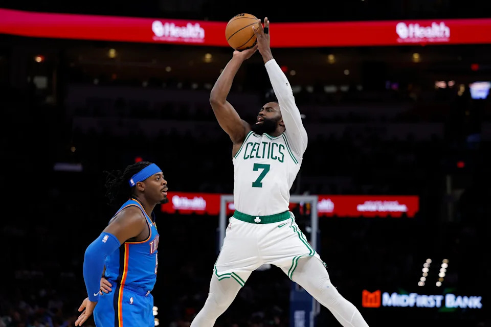 Boston Celtics guard/forward Jaylen Brown (7) shoots over Oklahoma City Thunder guard Luguentz Dort (5) on March 12 at Paycom Center.
