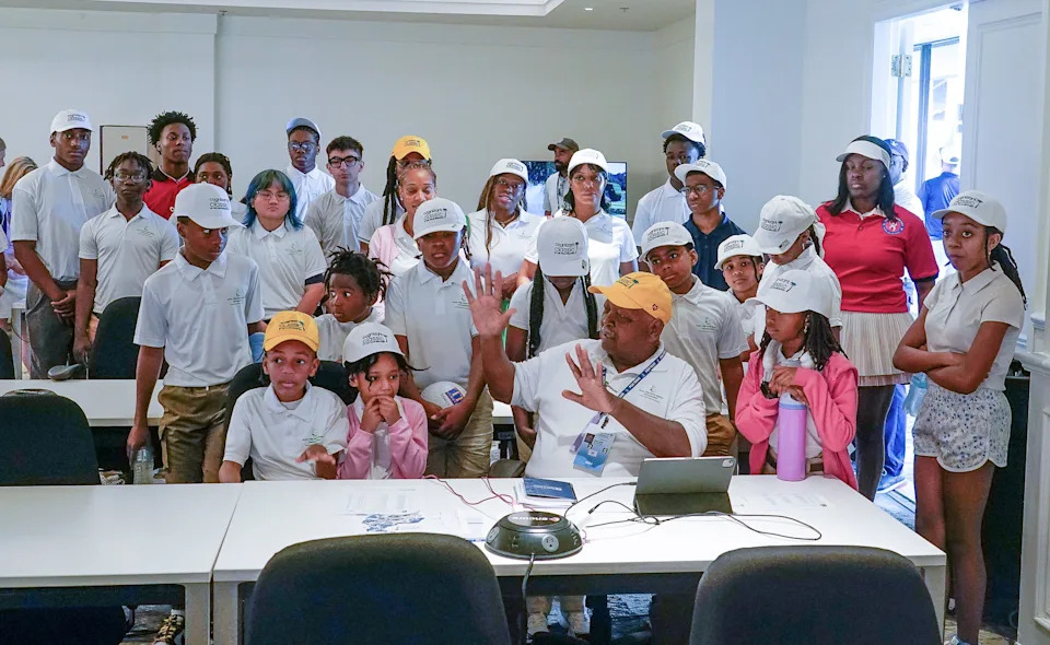 Students from the Inner City Youth Golfers' "Back of the House" tour gather around founder Malachi Knowles (center) in the media room at the Cognizant Classic in the Palm Beaches at PGA National Resort in Palm Beach Gardens on Feb. 28, 2026.