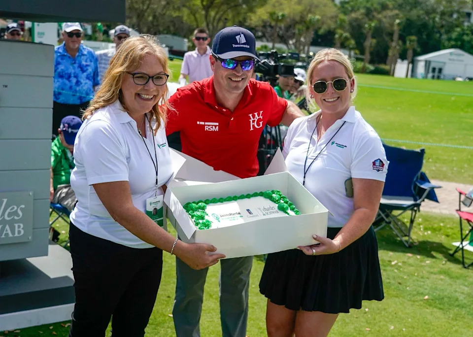 Zach Johnson poses for a photo with staff members in front of a cake welcoming him and Ben Crane to the PGA Tour Champions during the first round of the James Hardie Pro Football Hall of Fame Invitational at The Old Course at Broken Sound Club on Friday, March 6, 2026, in Boca Raton, FL.