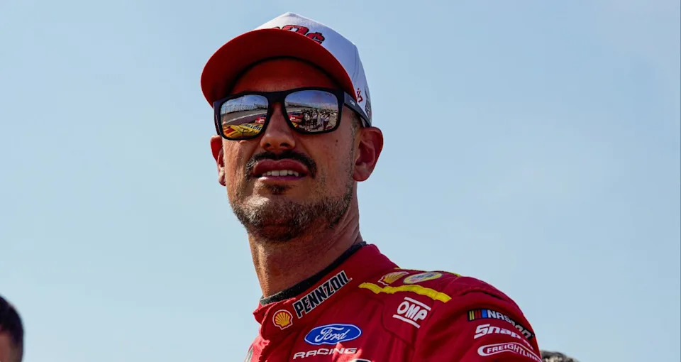 Joey Logano looks on.