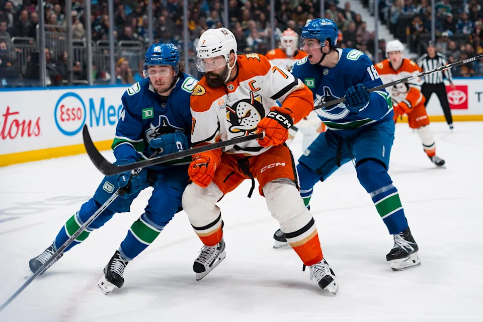 Mar 24, 2026; Vancouver, British Columbia, CAN; Vancouver Canucks forward Linus Karlsson (94) and forward Drew O'Connor (18) battle with Anaheim Ducks defenseman Radko Gudas (7) in the second period at Rogers Arena. Mandatory Credit: Bob Frid-Imagn Images