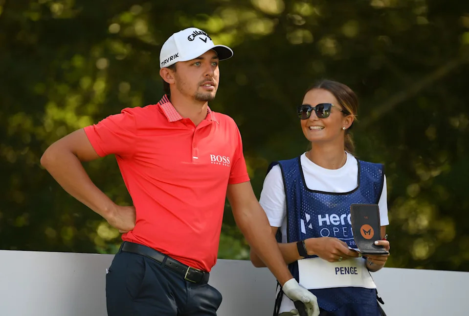 Marco Penge of England speaks to his caddie Sophie Lamb on the 18th during Day One of the Hero Open at Marriott Forest of Arden on July 30, 2020 in Birmingham, England.