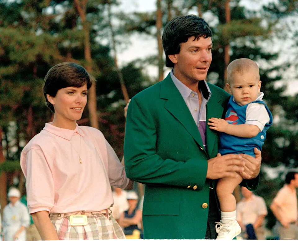 Larry Mize, 1987 Masters champ, wears his Augusta National Golf Club Green Jacket as he leaves ceremonies on April 13, 1987, after winning the tournament. With him are his wife Bonnie and son David. File photo