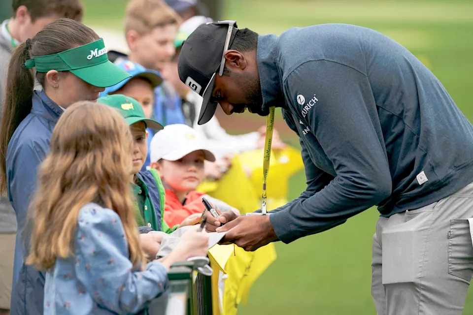 Sahith Theegala signs autographs during a practice round for The Masters at Augusta National Golf Club. (Photo: Danielle Parhizkaran-USA TODAY Network)