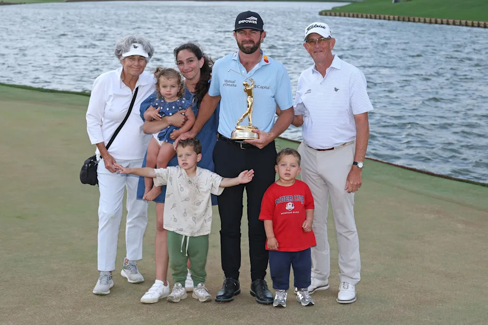 Cameron Young celebrates with his family on the 18th green after winning the 2026 Players Championship at TPC Sawgrass.