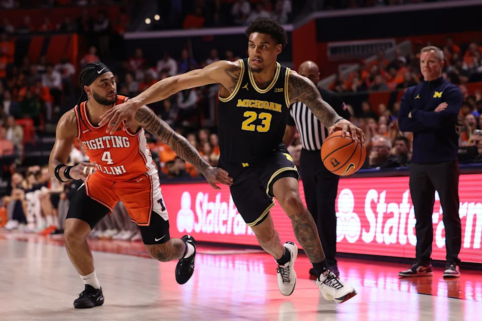 Yaxel Lendeborg #23 of the Michigan Wolverines dribbles past Kylan Boswell #4 of the Illinois Fighting Illini during the second half at State Farm Center on February 27, 2026 in Champaign, Illinois.