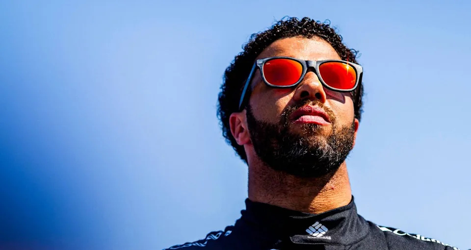 Bubba Wallace looks on.