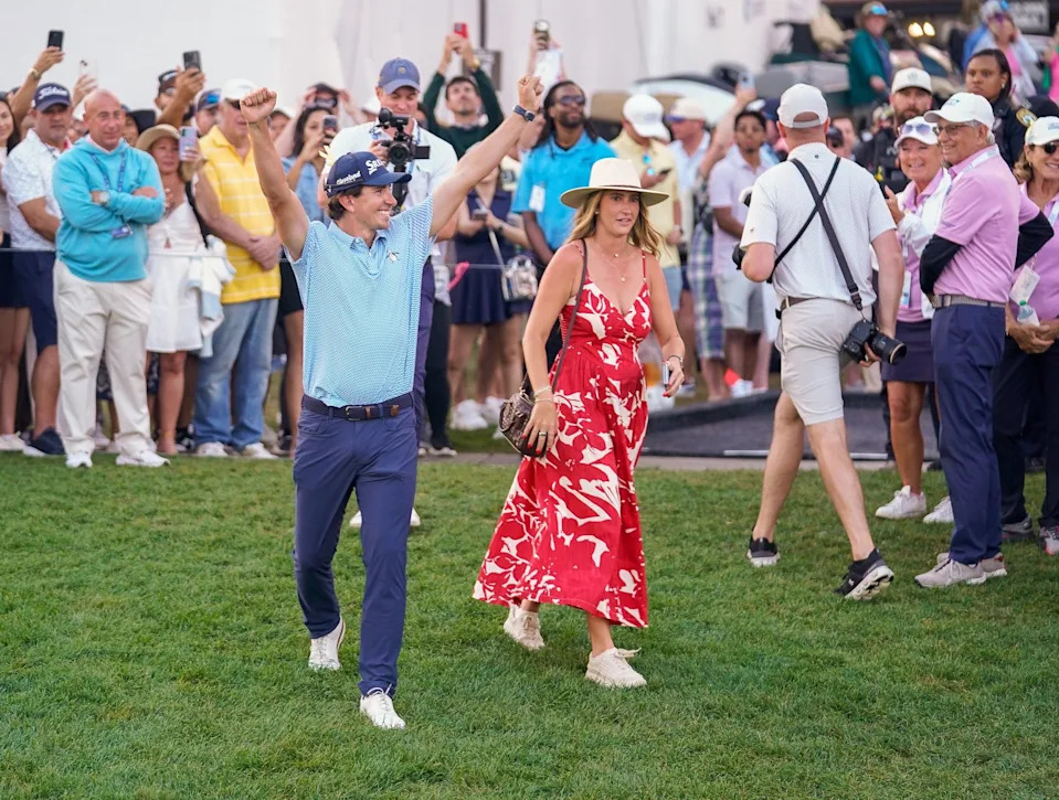 Nico Echavarria and his wife Claudia acknowledge the crowd as they walk to the 18th green for the trophy ceremony after winning the Cognizant Classic in the Palm Beaches at PGA National Resort & Spa on Sunday, March 1, 2026, in Palm Beach Gardens, FL.