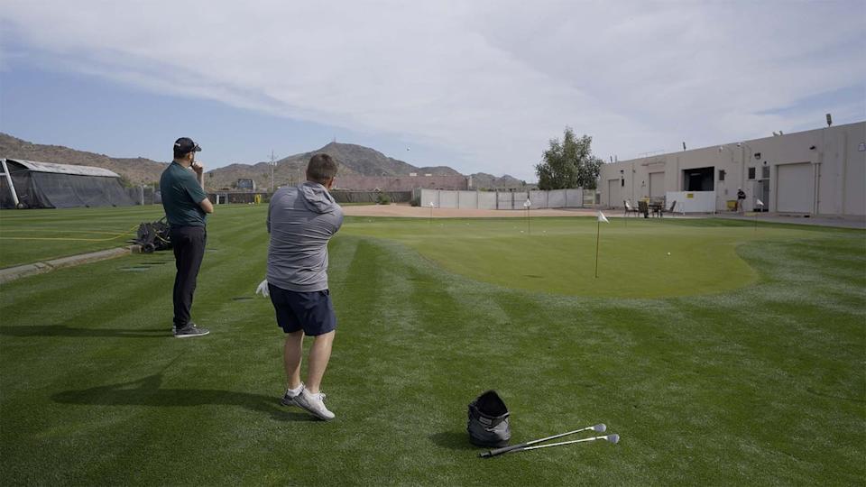 <span class="g-block-image__caption">Jake hitting chip shots with Adam Harding at PING Proving Grounds</span> <span class="g-block-image__credits">Mark Hannan / GOLF</span>