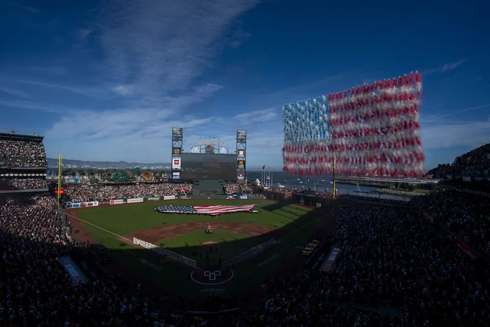Mar 25, 2026; San Francisco, California, USA; the San Francisco Giants and New York Yankees stand on the field during the playing of the national anthem at Oracle Park. Mandatory Credit: Cary Edmondson-Imagn Images