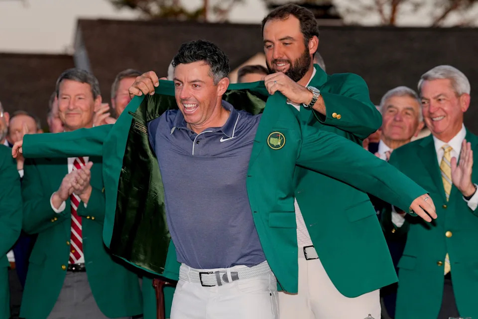 Apr 13, 2025; Augusta, Georgia, USA; Scottie Scheffler places the green jacket on Rory McIlroy during the green jacket ceremony during the final round of the Masters Tournament at Augusta National Golf Club. Mandatory Credit: Kyle Terada-Imagn Images