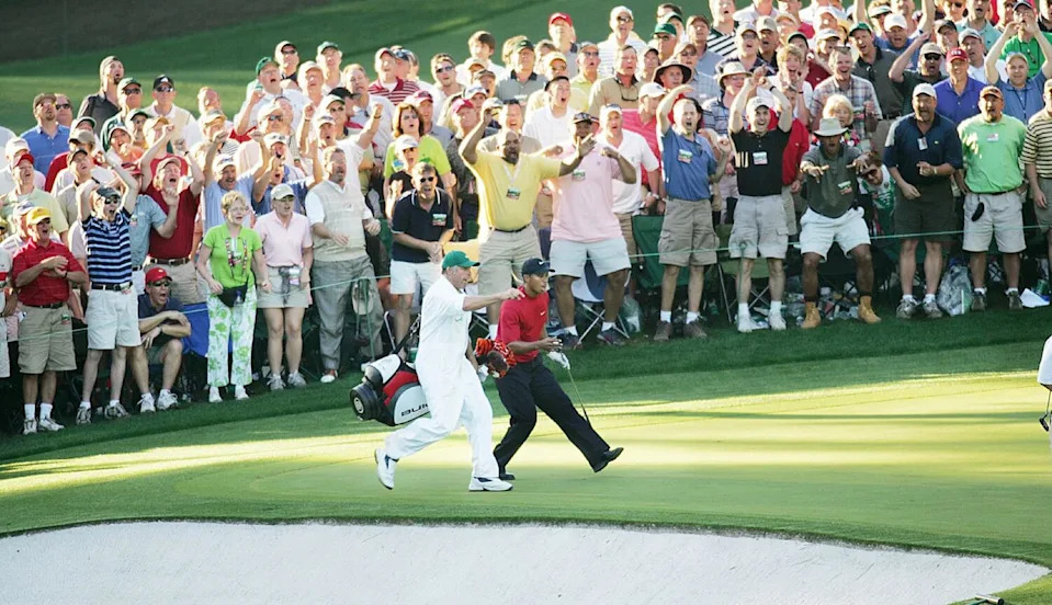 Tiger Woods and caddie Steve Williams watch Woods' chip shot teeter at the edge of the cup at No. 16 during the 2005 Masters