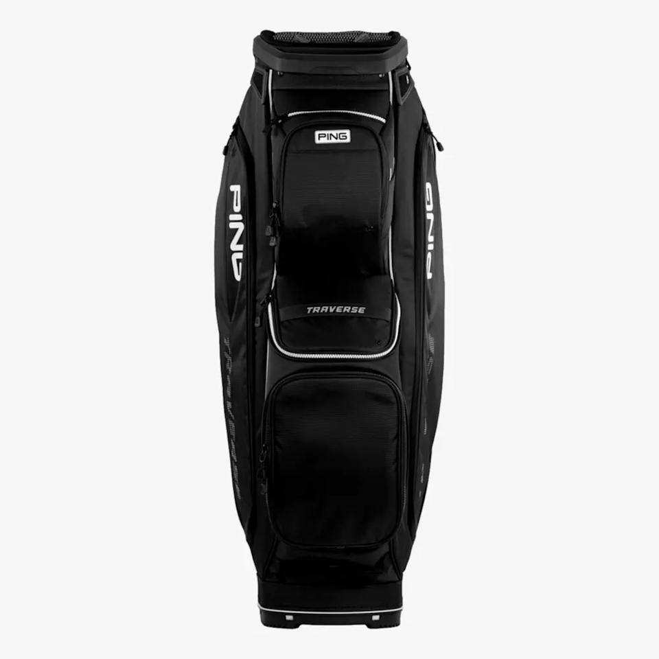 A black PING Traverse golf bag, one of the best golf bags 2026, stands upright against a plain white background. It features multiple zippered pockets and distinctive white PING branding on the sides.