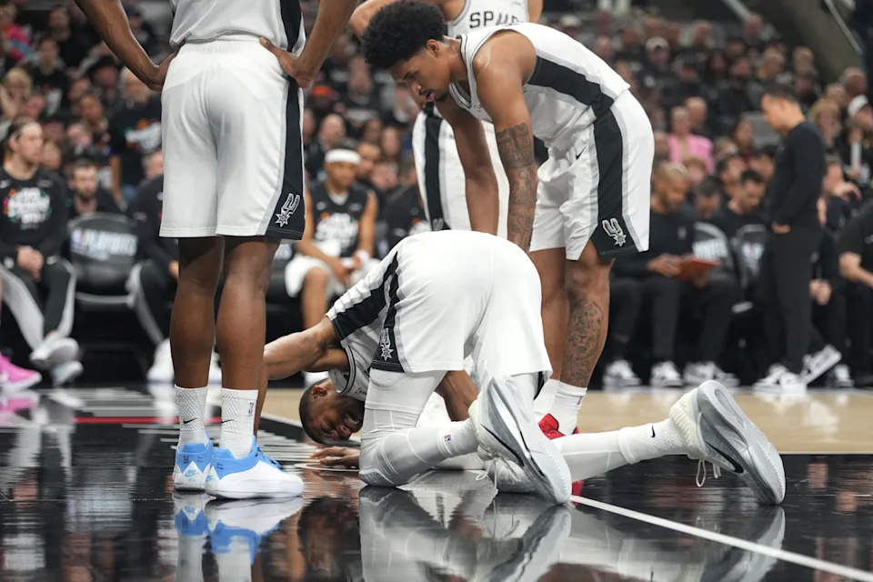 San Antonio Spurs forward Victor Wembanyama (1) reacts beside guard Dylan Harper (2) after falling to the ground during the first half of game two of the first round of the 2026 NBA Playoffs against the Portland Trail Blazers at Frost Bank Center.