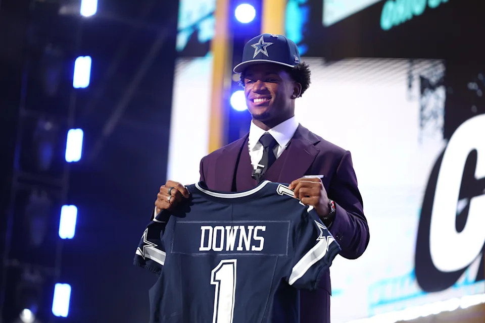 Caleb Downs of Ohio State celebrates after being selected eleventh overall pick by the Dallas Cowboys during Round One of the 2026 NFL Draft at Acrisure Stadium on April 23, 2026, in Pittsburgh, Pennsylvania.