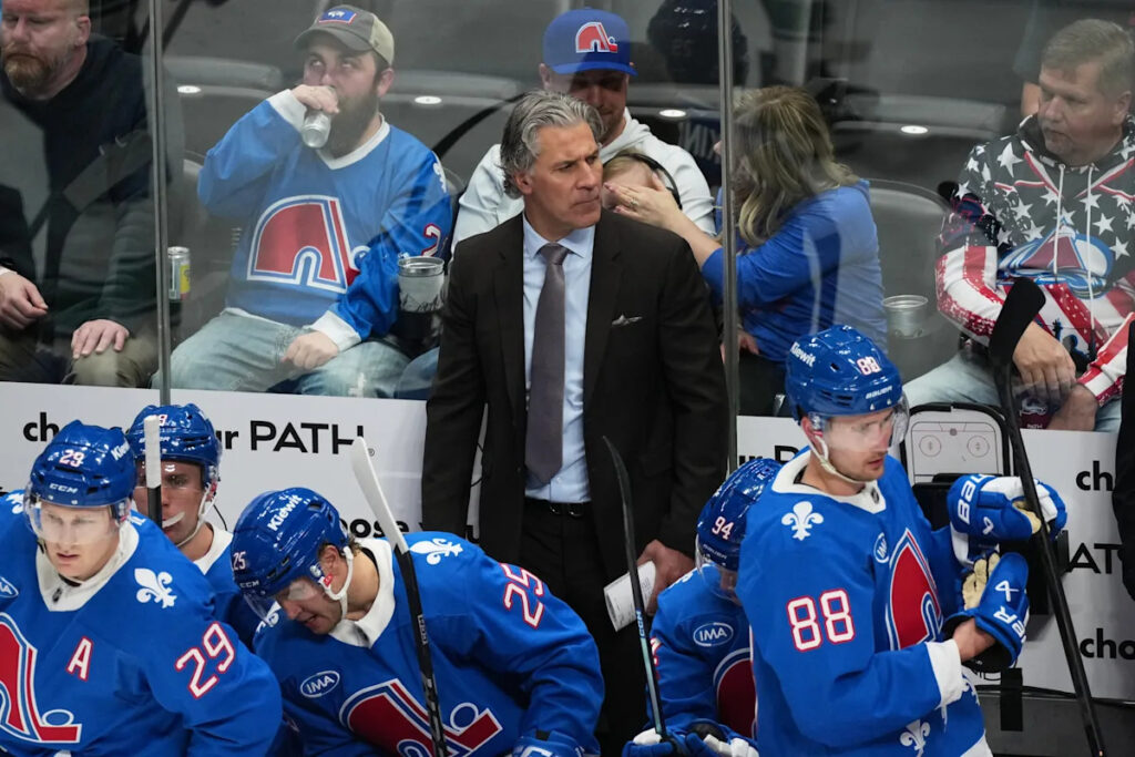 Avalanche coach Jared Bednar returns to the bench after taking a puck to the face last weekend