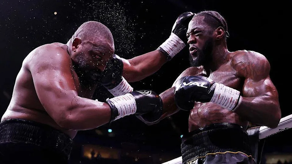 Deontay Wilder and Derek Chisora exchange punches during their heavyweight bout
