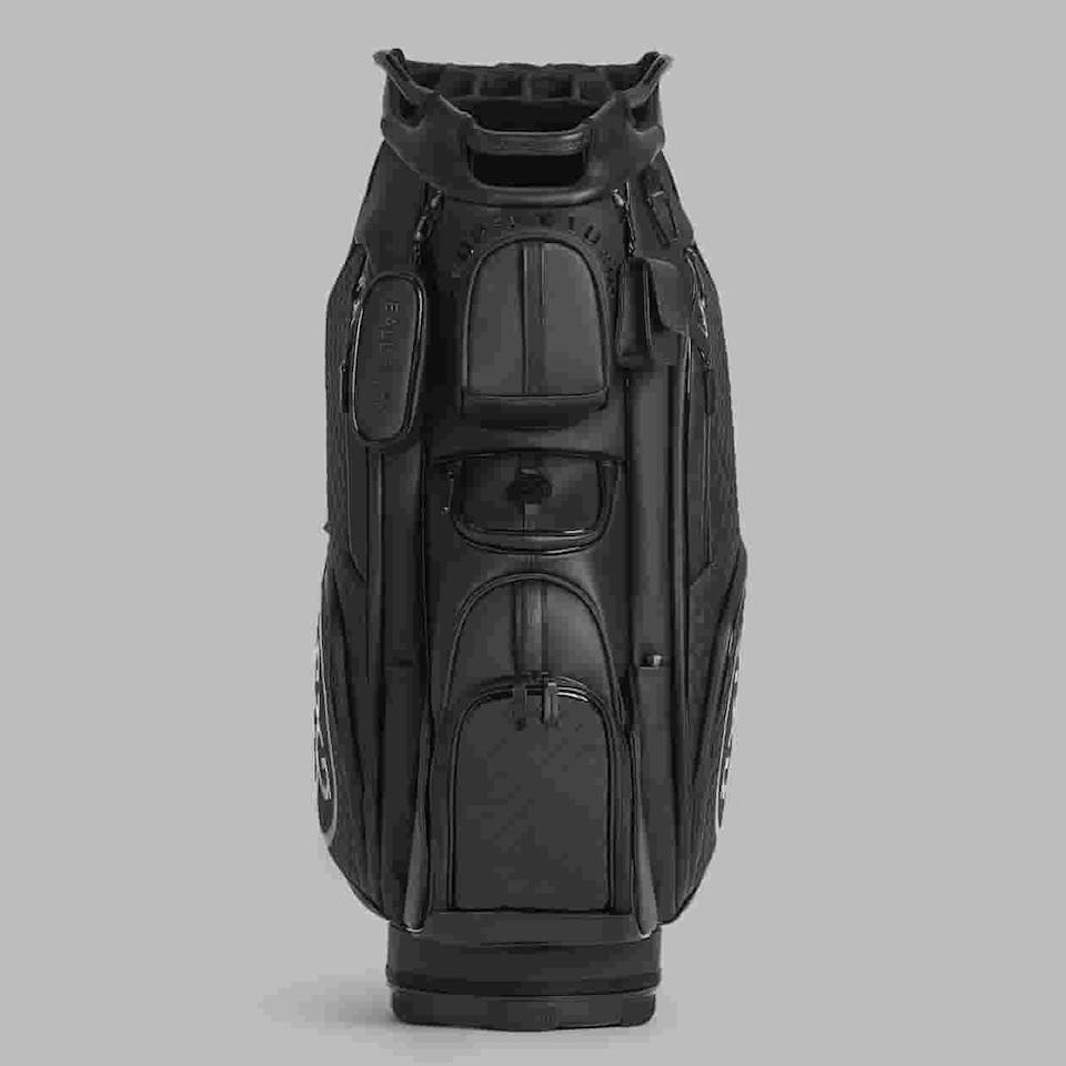 A black golf bag with multiple zippered pockets and compartments, viewed from the front against a plain gray background. The bag features sturdy handles and a sleek, modern design—an excellent pick among the best golf bags 2026.