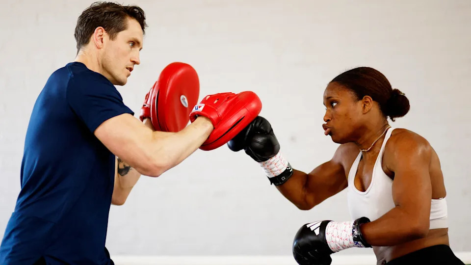 Caroline Dubois works the pads with trainer Shane McGuigan