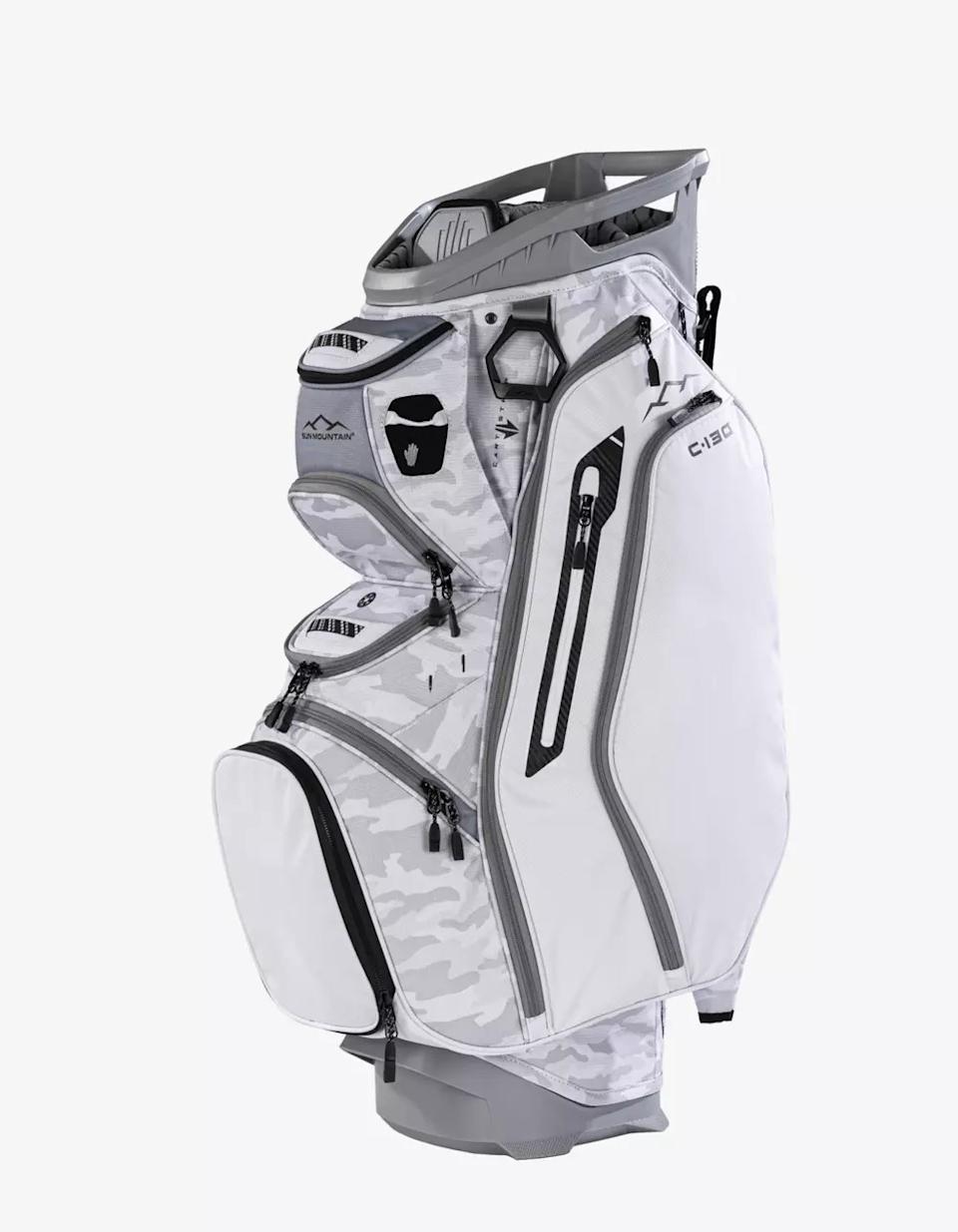 A white and light gray camouflage golf bag with multiple zippered pockets, black accents, and a sturdy base, standing upright on a white background—an excellent choice among the best golf bags 2026.