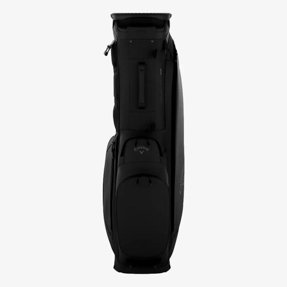 A black Callaway golf bag stands upright, viewed from the front, displaying several zippered compartments and the Callaway logo on the front pocket—an ideal choice among the best golf bags 2026.